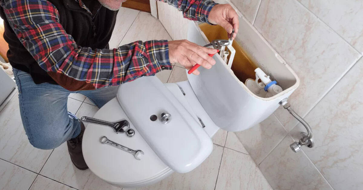 plumber repairing toilet